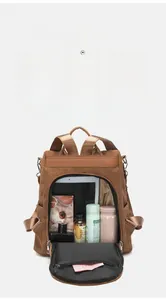 Interior view of brown corduroy backpack showing large capacity for laptop and cosmetics
