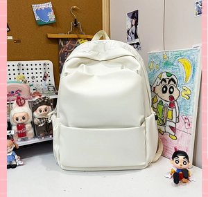 Detail view of cream white minimalist school backpack with gothic letter embroidery