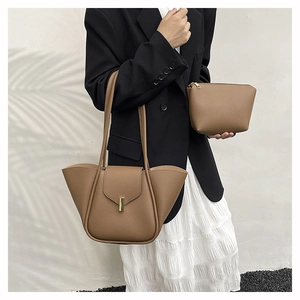 Detail of dark camel lychee grain leather handbag set featuring large tote and small pouch