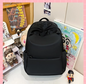 Close-up of black backpack featuring gothic embroidery and durable water-resistant fabric