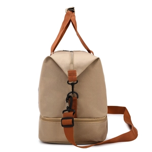 Beige canvas travel duffel bag with orange straps and separate bottom compartment