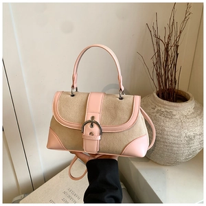 Detail of vintage patchwork handbag with pink leather trim and retro silver buckle