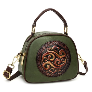 Vintage green leather crossbody bag with ethnic floral embossed round emblem