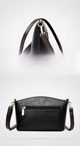 Detailed views of the black pebble leather crossbody bag showing side and back profile