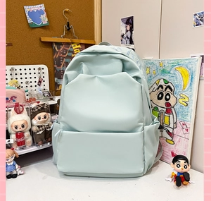 Detail view of mint green water-resistant nylon backpack with stylish printed shoulder straps