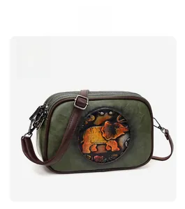 Détails du sac carré vert foncé avec motif d'éléphant en relief et finitions zippées