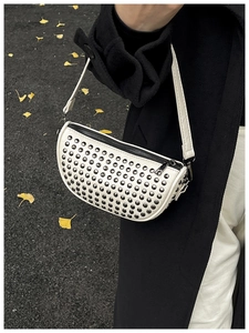 White semi-circle rivet crossbody bag with silver studs on textured white PU leather