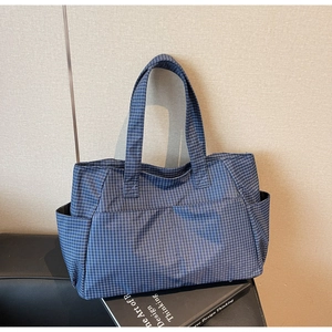Blue gingham tote bag with multiple pockets and functional side compartments for travel