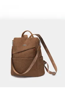 Close-up of brown corduroy backpack with leather trim and adjustable shoulder straps