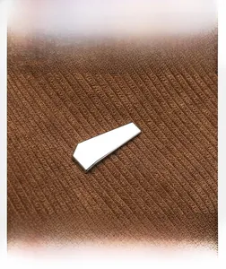 Macro view of brown corduroy fabric texture and silver geometric metal hardware detail