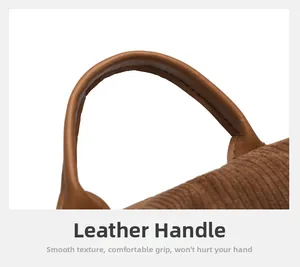 Close-up of durable leather handle on brown corduroy backpack with reinforced stitching