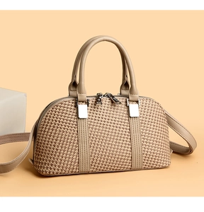 Detailed view of beige woven handbag texture with dual zippers and silver hardware
