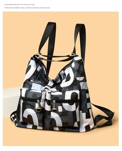 Close-up of casual nylon backpack with letter print and dual zipper pockets