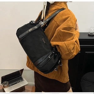 Detail of black utility shoulder bag with silver eyelets and Suvora metal logo