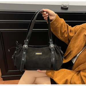 Detail of black tote bag featuring matte texture, drawstring pleats and Suvora logo