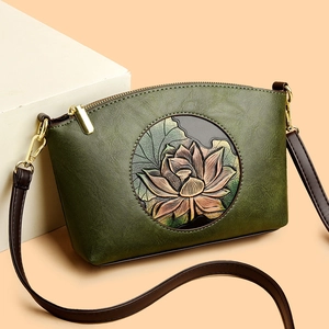 Vintage green leather crossbody bag with embossed lotus and gold metallic hardware