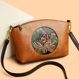 Brown vintage shell-shaped crossbody bag with embossed lotus floral pattern and gold hardware