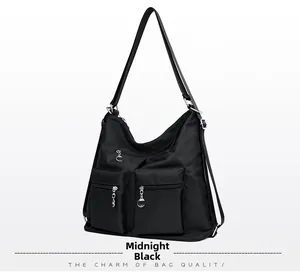 Front detail of hobo bag in Dark Night Black showing nylon texture and silver zippers