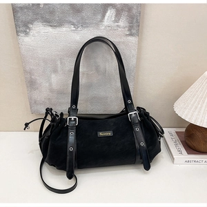 Close-up of black suede hobo bag with Suvora logo, silver hardware and drawstring side detail