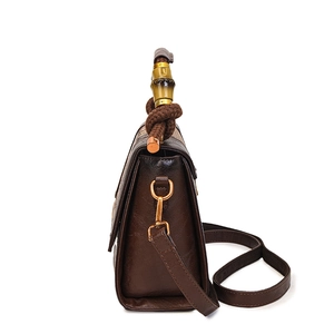 Vintage brown leather handbag with bamboo handle and adjustable shoulder strap