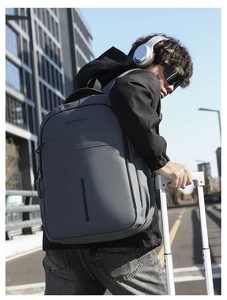 Grey business travel backpack with waterproof coating shown in urban outdoor setting