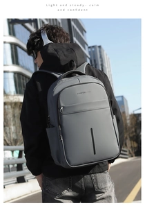 Detailed view of grey waterproof business backpack with smooth matte texture and ergonomic handle