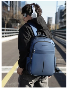 Close-up of waterproof fabric and front zipper pocket on blue travel backpack