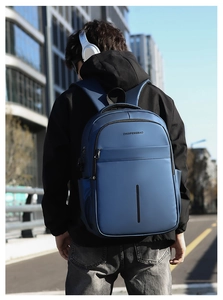Waterproof navy blue travel backpack for men featuring ergonomic cushioned shoulder straps