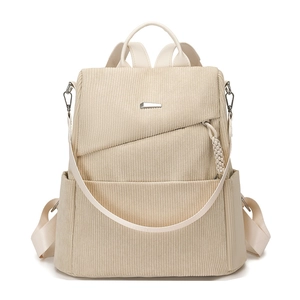 Minimalist beige corduroy backpack for women with front metal accent and woven charm