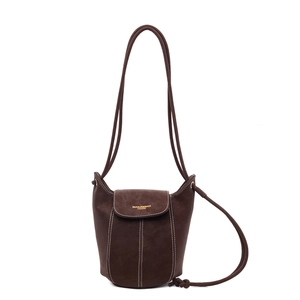 Minimalist coffee brown suede bucket bag with contrast stitching and shoulder strap
