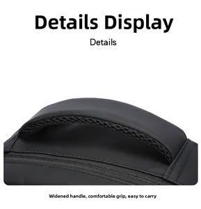 Close-up of a wide ergonomic handle with breathable mesh on a black travel backpack