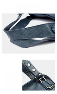 Detail of dark blue leather handbag showing lychee texture and silver metal hardware
