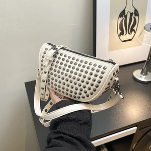 White rivet-studded half-moon shoulder bag with adjustable strap and silver metal studs