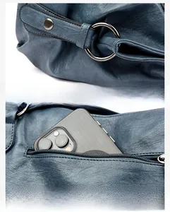 Detail of silver hardware ring and secure back zipper pocket on navy blue leather tote