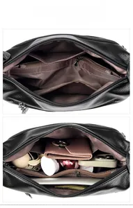 Internal display of black lychee leather bag showing brown lining and storage capacity