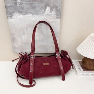 Vintage burgundy leather tote bag with drawstring detail and adjustable straps