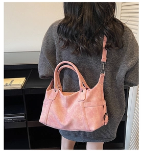 Detailed view of pink vintage tote bag with retro matte texture and shoulder strap