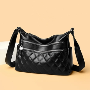 Quilted black leather crossbody bag with silver hardware and adjustable wide shoulder strap