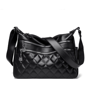 Minimalist black pebble leather crossbody bag with quilted panel and silver zippers