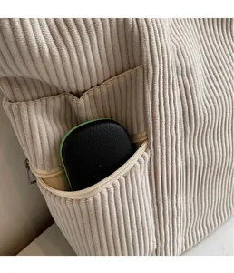 Detail of corduroy tote bag showing spacious interior zip pocket and ribbed texture