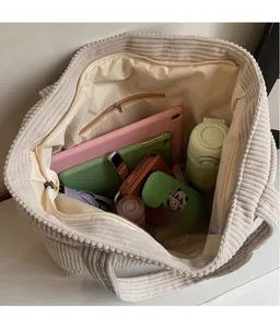 Interior view showing the large storage capacity of this cream corduroy tote bag