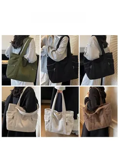 Detailed view of large corduroy tote bag showing multiple colors and side zipper pocket