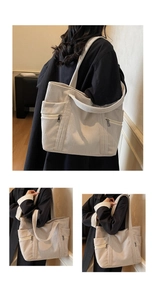 Detail view of large corduroy tote bag showing textured fabric and metal zip pockets