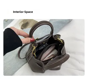 Interior view of brown bucket bag showing large capacity and zipper compartment