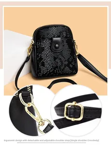 Detail of black snake pattern crossbody bag showing detachable strap and gold hardware