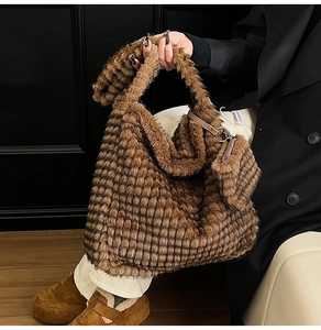 Close-up of brown faux fur tote bag with square texture and matching coin purse