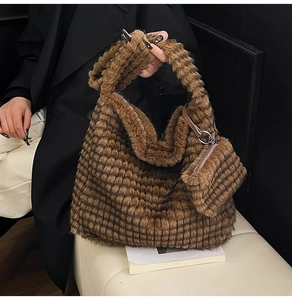 Detail of dark brown plush tote bag featuring a soft quilted texture and matching pouch