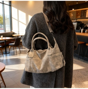 Detail of vintage gray tote bag with matte texture and functional side pockets for women