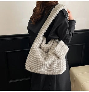 Detail of beige plush hobo bag with quilted texture and detachable coin purse
