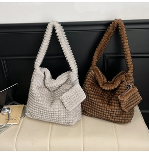Detailed view of large plush cloud bags in gray and brown with matching mini pouches